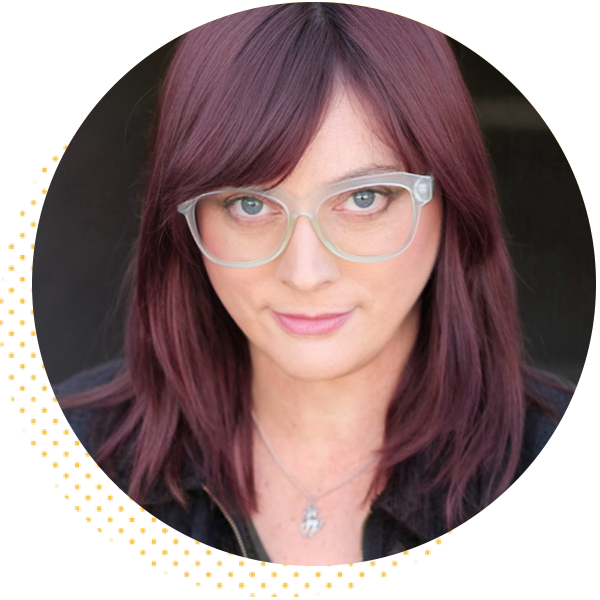 Portrait of a woman with long, purple hair and glasses, presenting a confident expression. The image is framed in a circular design, emphasizing her face and features.