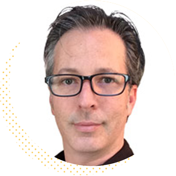 Professional headshot of a man with glasses and short gray hair, set against a white background, conveying a confident and approachable demeanor.