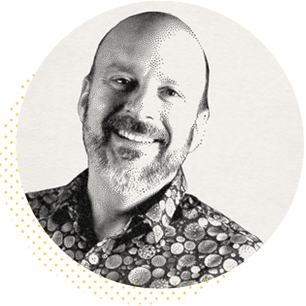 Smiling man with a beard wearing a colorful patterned shirt, set against a circular background. Ideal for showcasing personal branding or professional profiles.