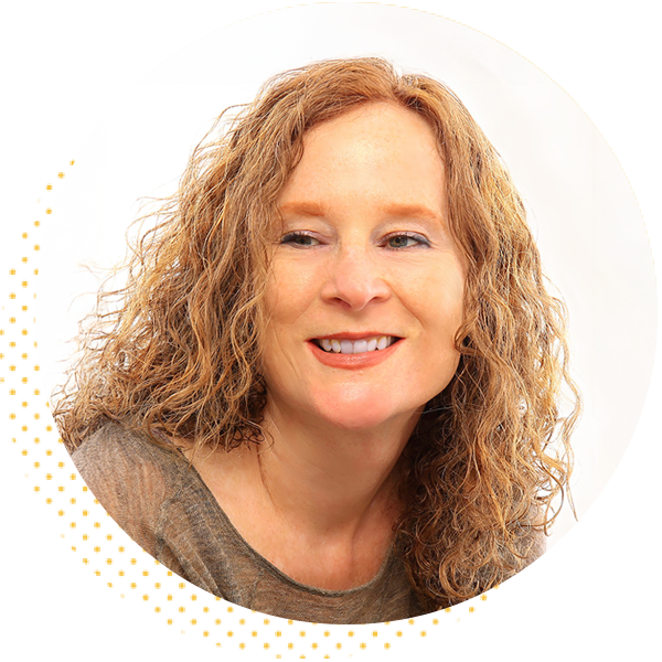 Smiling woman with curly hair wearing a gray top, set against a white background in a circular frame, exuding a friendly and approachable demeanor.