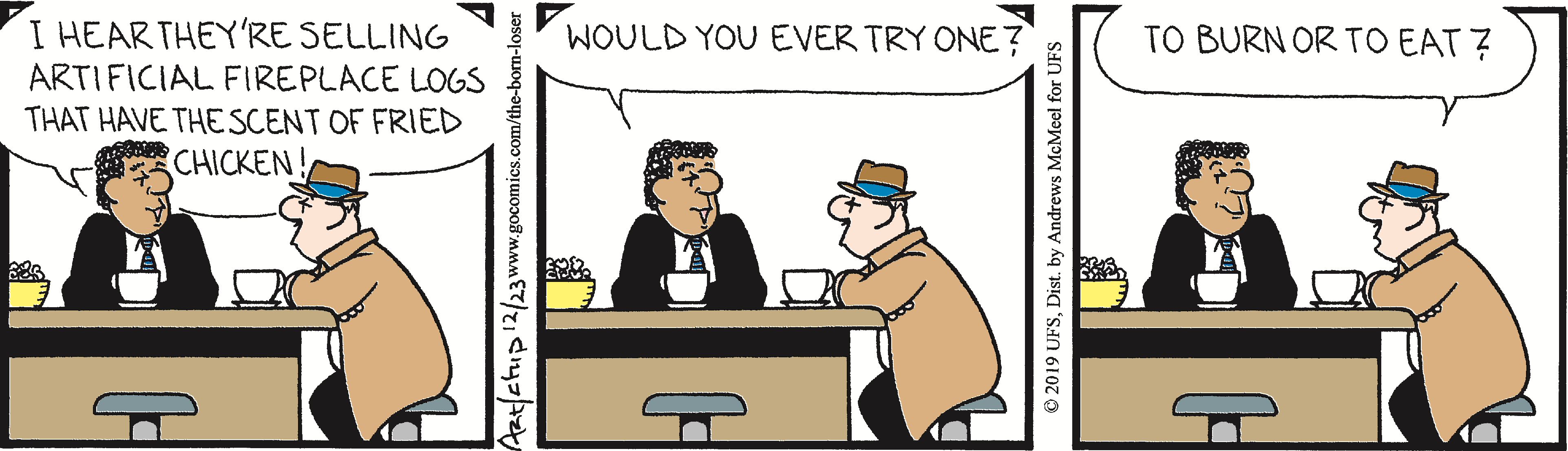 Two men sitting at a table in a café, engaged in conversation. One man, wearing a suit, appears curious, while the other, dressed in a trench coat and hat, responds thoughtfully. A bowl of popcorn is on the table. The scene captures a light-hearted exchange.